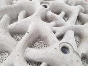 The intricate detailing and textures of the concrete seawall modules.