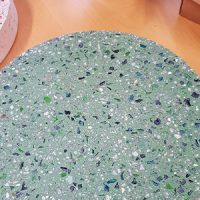 A mixture of blue and green glass fragments bring cool colour into this concrete paver.